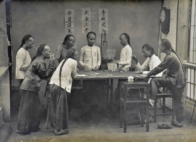 Fan Tan table surrounded by players