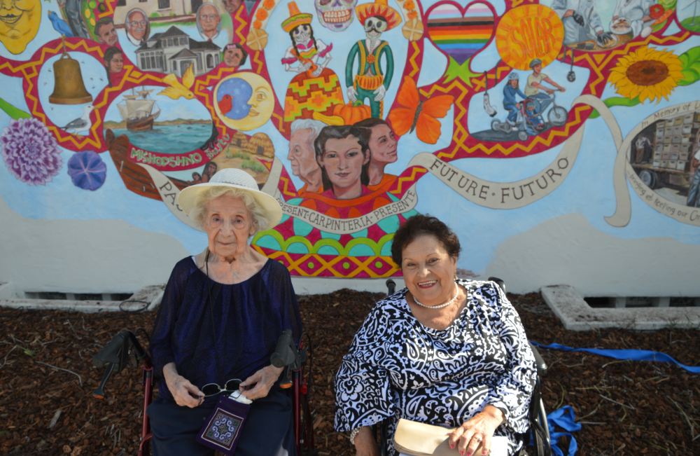 Josie Manriquez Villegas and Betty Bautista, former Aliso School students, in front of the Aliso School mural.